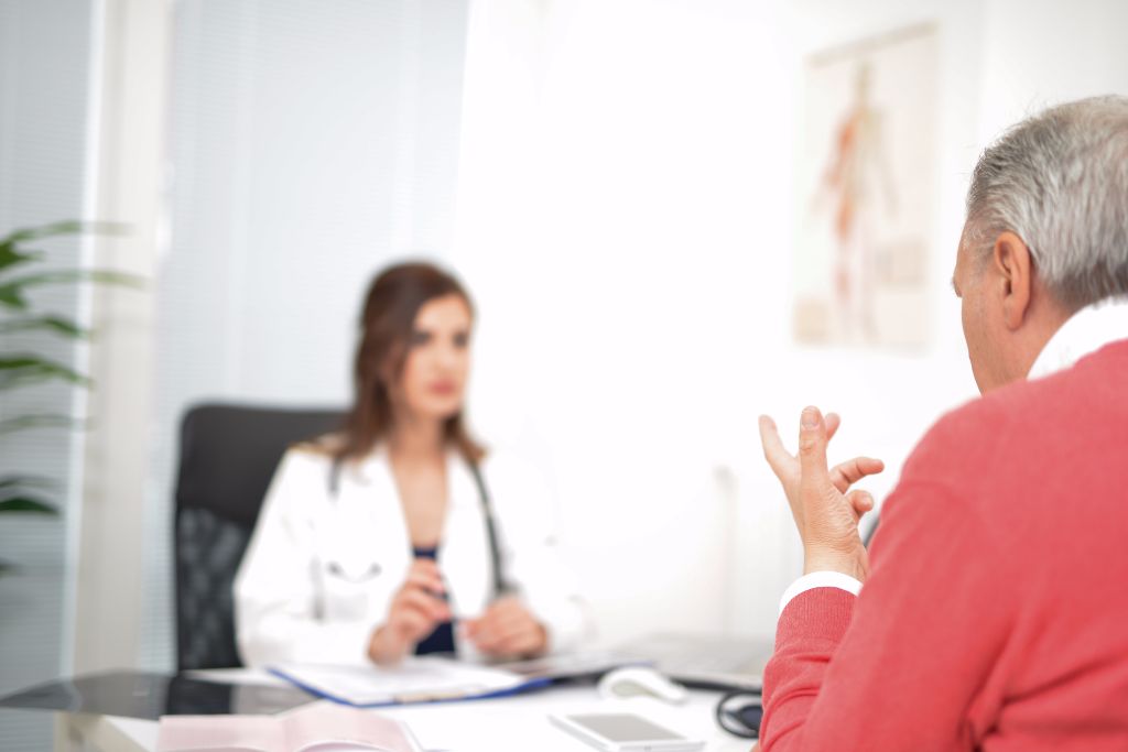 Doctor talking to her patient during a visit